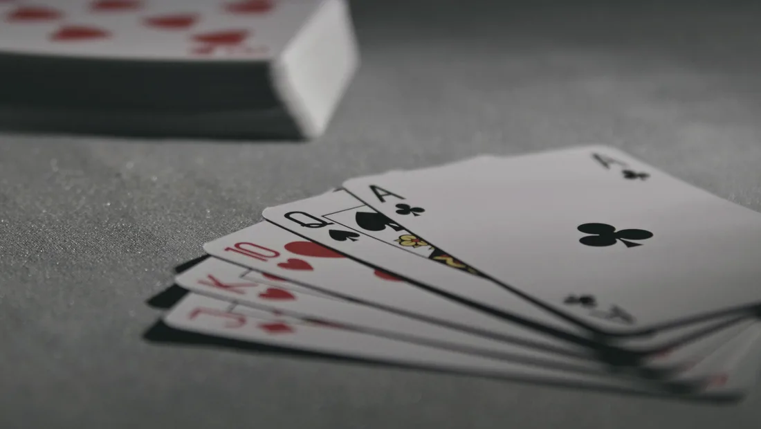 A quiet still life of playing cards on a muted surface